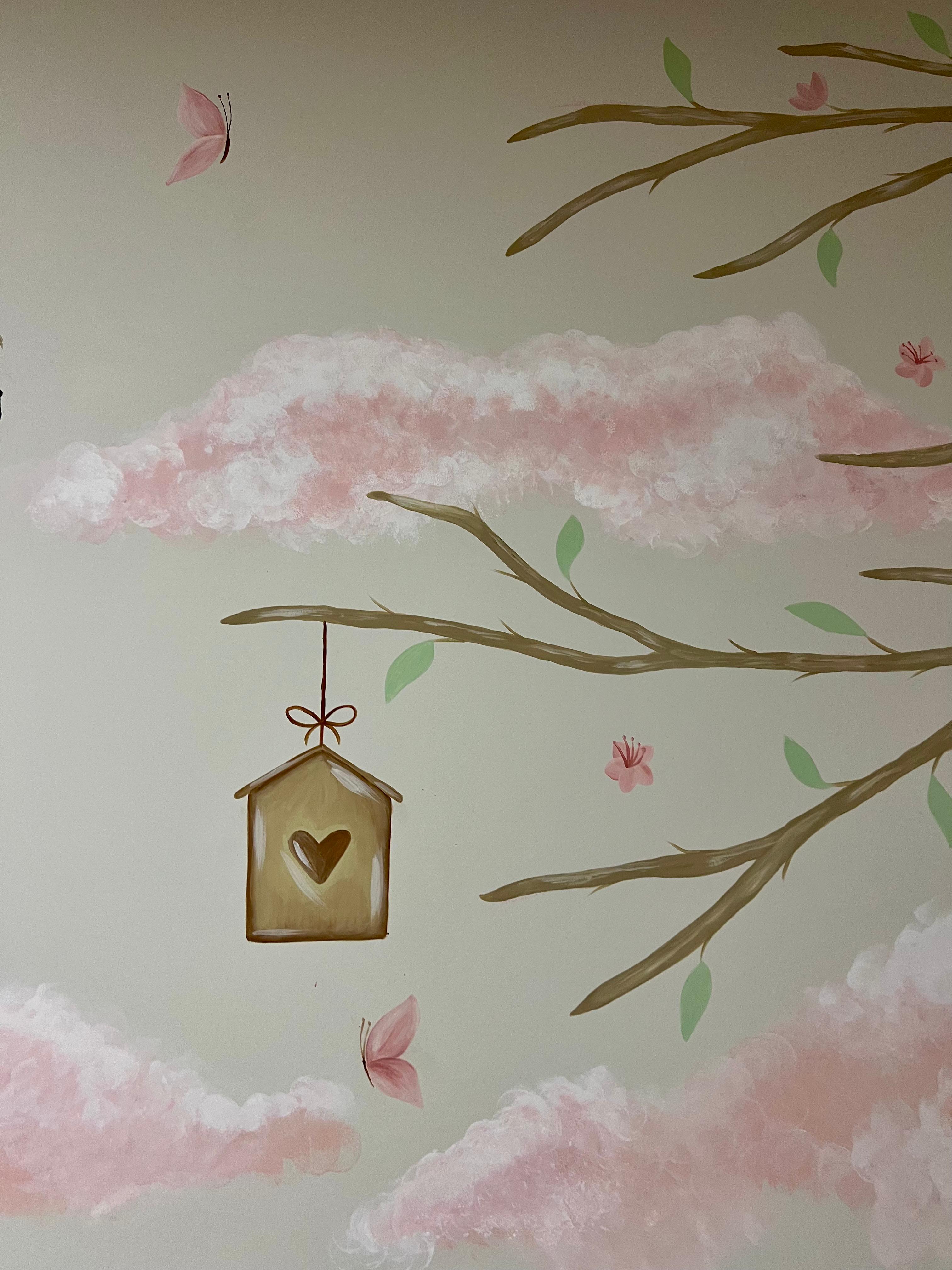 Detail of the little house suspended among branches and pink clouds