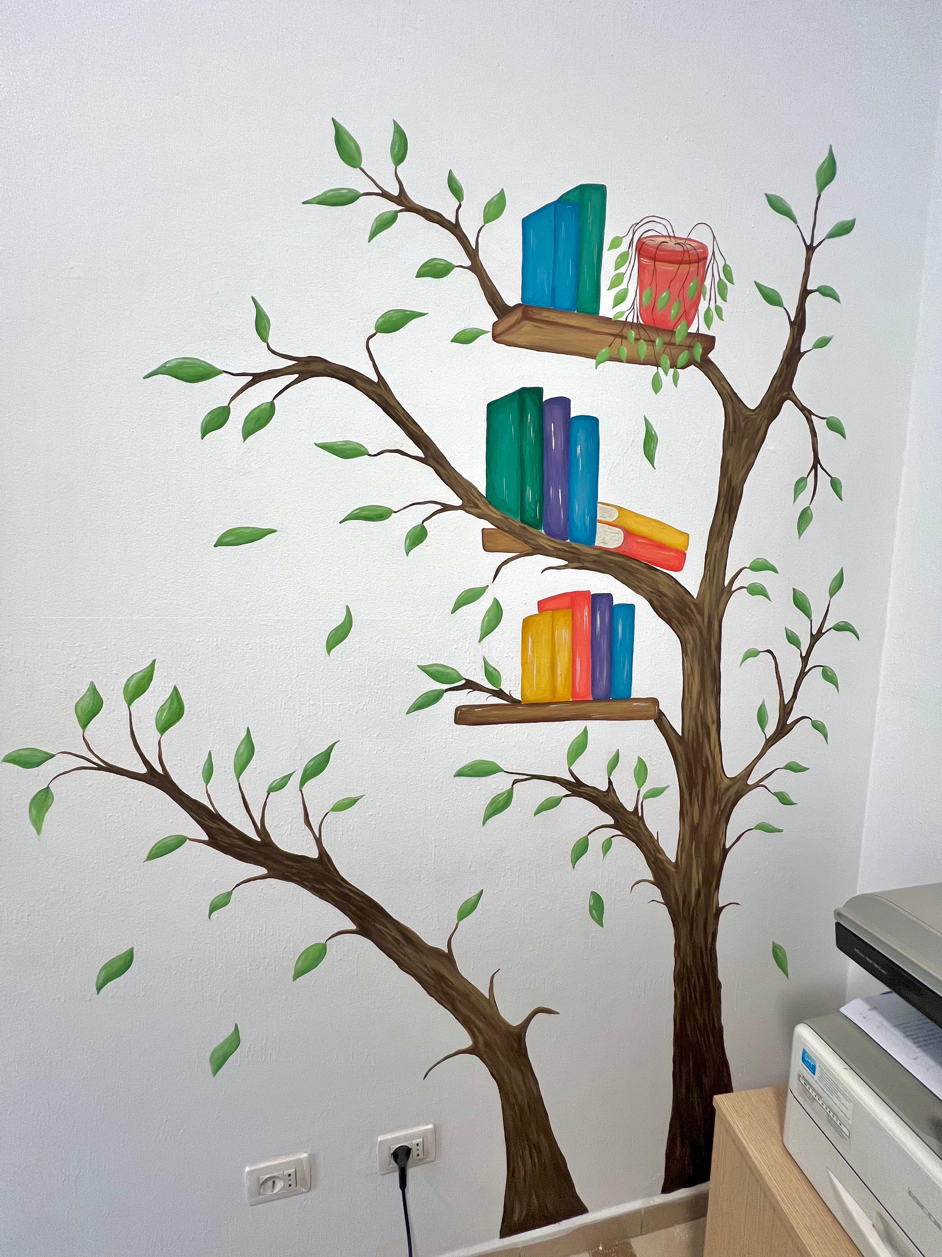 Another view of the tree-and-books mural, showing the overall wall composition